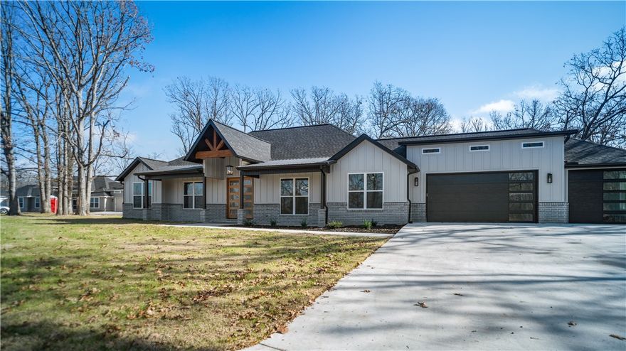 Enjoy Space, Privacy, and Nature Just 20 Minutes from Bentonville. 

Escape the city without sacrificing convenience. This stunning home offers the perfect blend of privacy and accessibility. Tucked on a wooded 1.36-acre lot, you'll enjoy the peace of nature, mature trees, and the space to truly spread out. Inside, the home features 4 spacious bedrooms and 3 full bathrooms, thoughtfully designed to maximize every square foot. The oversized garage gives you room for storage or a workshop, while the 10 ft ceilings in the living area and the expansive entryway with 8 ft double front doors create a grand, welcoming feel from the moment you walk in. 

Luxury vinyl plank flooring runs throughout the home, adding both durability and style. Step outside and relax on not one but two covered patios in the front and back, ideal for morning coffee or evening wind downs surrounded by nature.This property brings the best of both worlds. Peaceful living with modern luxury just minutes from town.