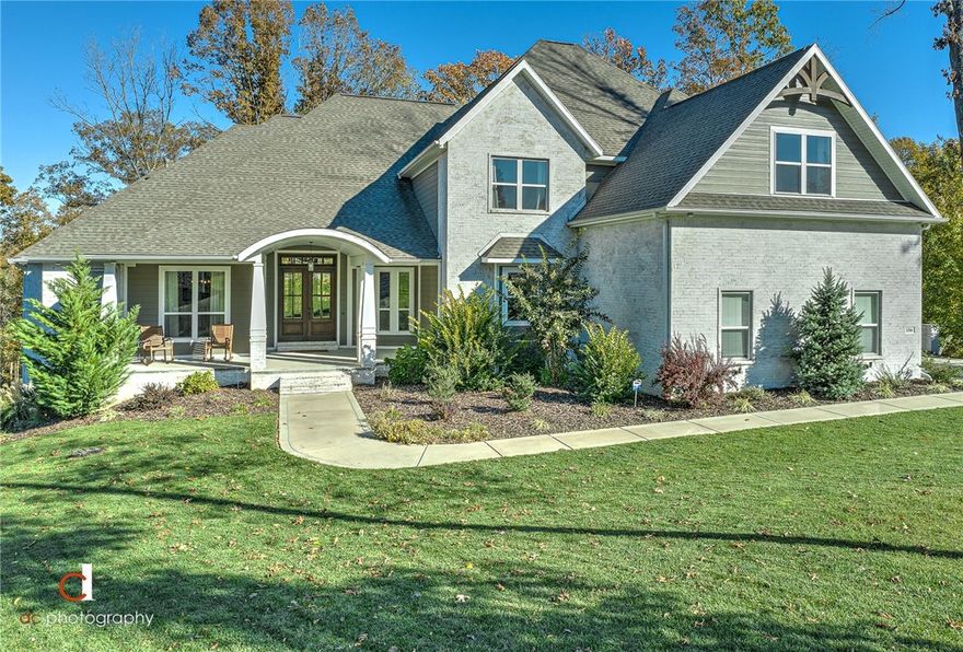 Welcome to pure perfection, this stunning custom built home is located in the highly sought after Versailles Subdivision in a culdesac on 1.82 acres, with beautiful views & a secluded back yard.  A lovely covered front porch & breathtaking entrway invites you in with gorgeous white oak wood floors through out most of the main floor.  Large open living room with beautiful built-ins showcasing a cozy rock fireplace, & cathedral ceiling framed by warm wood beams.  Enjoy entertaining in a chef's dream kitchen with a gas stove, double oven & a warming drawer that provides everything you need for creating amazing meals.  Large eat-in island, dining area in the kitchen plus a formal dining room, means everyone has a seat at family & friend gatherings.  French doors open up to a covered deck with an amazing view & wood burning fireplace.  The owner's retreat & junior suite also located on the main floor, along with a 2nd living/game room.  Laundry room on main floor with connections for 2 washers & dryers.  Amenities sheet