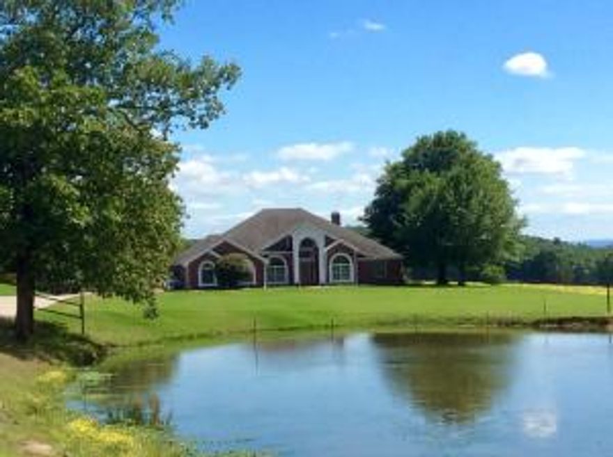 WELCOME HOME TO THE RANCH, 237 Acres of beautiful pastureland with good fencing. cross fenced 8 times, 5 ponds, 3 creeks and one unbelievable view! The Custom built home offers private living with luxurious amenities. 4 bedroom, 3 bathroom, formal dining room, custom office with arched windows. The sunken living-room centers the home with a large fireplace bookshelves and tall ceilings. The Chef's going to be happy in this kitchen with it's own breakfast nook overlooking the brick covered patio and built in hot tub overlooking your beautiful land. The lawn is manicured and fenced with 72 head sprinkler system. Horse and Cattle barns a hay barn too. Barns have electric and water, cattle scale, iron railings, round pen. New Geothermal system make utilities low. Hay pastures separate fenced.