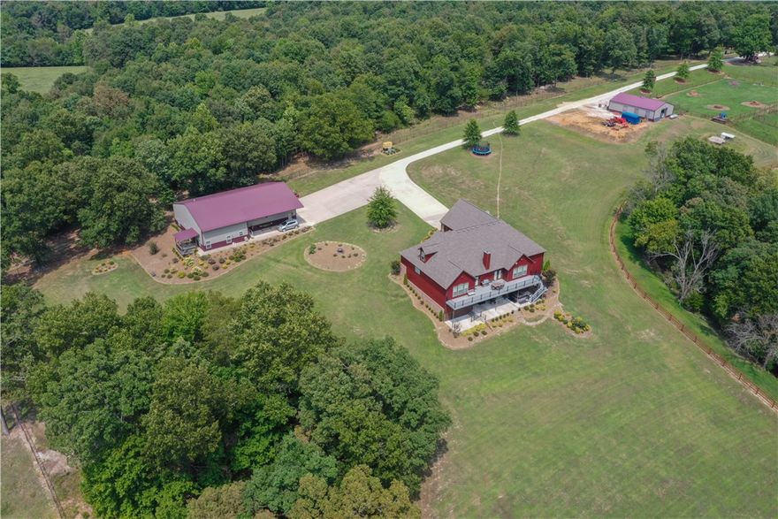 Great location with great views in the center of Northwest Arkansas located just south of Tontitown. Five Bedroom, three full baths and two half baths. Walk out basement with your own sports bar all in the main house.  1500 sq ft Mother In Law suite with one bedroom, one bath, kitchen and living room.  Along with 1600 sq ft shop space. Also on the property you will find a Horse stable with six stalls and tack room all on ten acres, perfect for horses, cattle, etc...