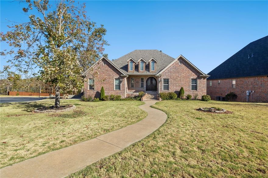 This stunning home is nestled on an oversized corner lot in the well-established Chapel Hill Subdivision, and is located minutes from Crystal Bridges Museum, the Amazeum, Alice Walton School of Medicine, and I49. Cathedral ceilings welcome you to the home, complemented by an open and bright yet traditional vibe. The chef's kitchen has been updated with painted cabinets, new floors, countertops and backsplash. Entertain outdoors on the serene covered deck that opens to the backyard. Additionally, a workshop allows for easy storage for lawn equipment. Retreat to the large primary suite boasting custom tray ceilings and a luxurious updated en-suite bathroom. The additional bedroom on the main level may be used as a flex space or guest room. Downstairs, you will discover a spacious game room with built-in cabinets, 2 bedrooms, 1.5 baths, and a second living room with access to the lower level deck. Experience the amazing community amenities of Chapel Hill all while being conveniently in a prime Bentonville location.