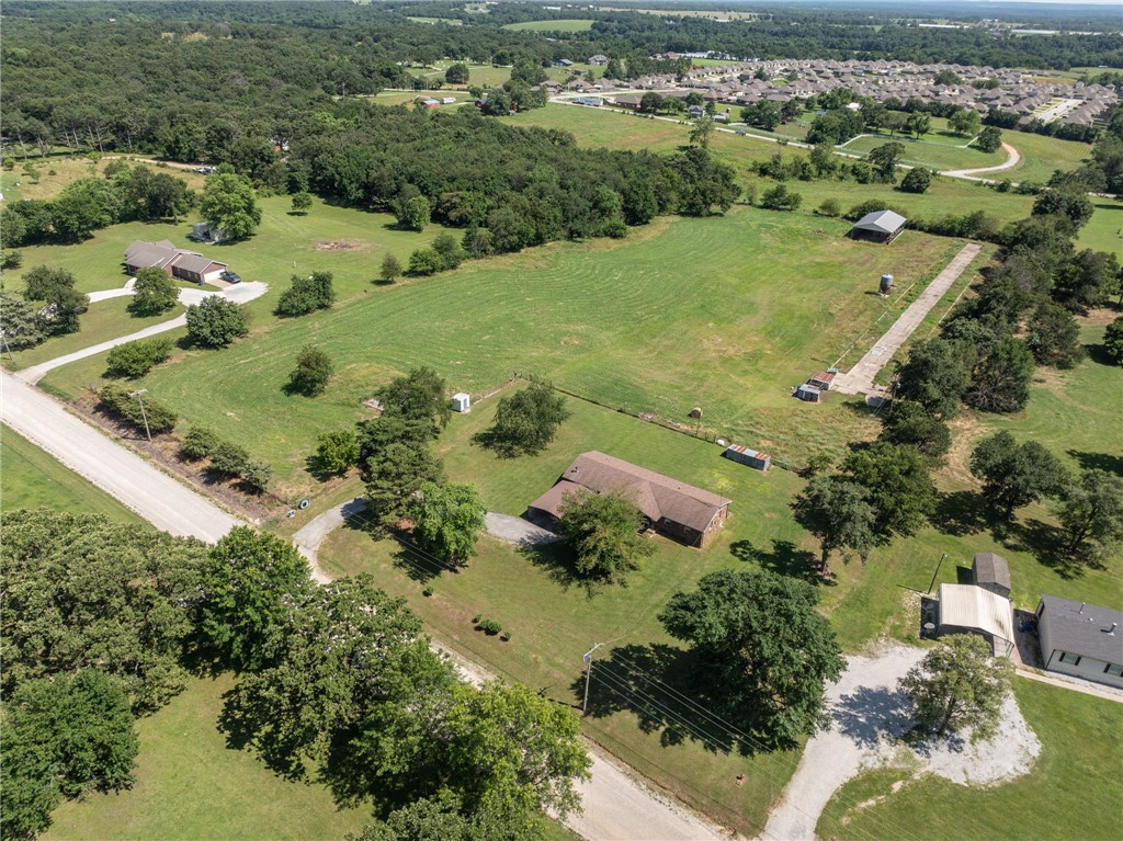 Don’t miss your chance to own a piece of paradise! This spacious rock farmhouse has 3bds 2 bath and almost 2,000sqft. Plus, it sits on this beautiful, fully fenced 7.47-acre property that would be perfect for horses, cows, and chickens. The possibilities are endless.. The home features a covered front porch and, open back deck. It has two wells, both functioning and 1 with a new pump. Newer roof, carpet, windows, storm doors, insulation in attic, vapor barrier and insulation in crawlspace. New HVAC and water heater last year. Septic was pumped last year. Pasture is fenced on all sides, front yard is open. Located outside of Gentry city limits and only minutes to town, and main highways.