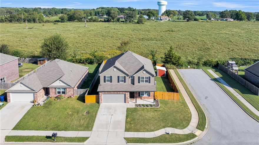 Welcome home to this beautifully designed two-story nestled on a prime corner lot — just two miles from the heart of downtown Siloam Springs. From the moment you step inside, the open layout draws you in with a seamless flow that's perfect for both entertaining and everyday living. Upstairs, you'll find a flexible bonus living area, four generous bedrooms, and two full baths — plenty of space for everyone to spread out. Step outside to your own private backyard retreat, complete with an above-ground pool for those long Arkansas summers, a convenient storage shed, and ample room to host friends and family. With modern finishes, thoughtful updates, and an unbeatable location, this one truly checks every box.