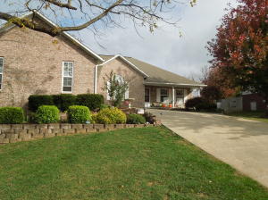 Big Price Reduction! Spacious, beautiful home in Golf Course Community. All brick 3(5) bedroom, 3 baths, hardwood floors, granite countertops, spacious kitchen, 2 fireplaces,craft room, super workshop in the lower level plus additional garage - perfect for golf cart, plus tons of storage and storm shelter.Well maintained and move-in ready.Approx 2000 sq ft on main and 2,000 sq ft/lower level!!