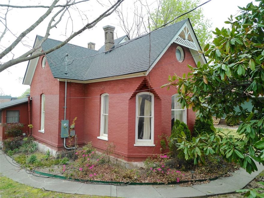 Unique Historical Home in the Heart of Downtown Rogers! Home is listed on the Arkansas Historic Preservation Program. Home features an upstairs bedroom with a half bathroom & plenty of storage area. The downstairs parlor can be another large bedroom on the main floor with another drop-down bedroom in the back of the home with a private door. The formal dining shows well with high ceilings, new windows with plantation shutters sitting off the large living room, beautifully put! The very high ceilings and large windows and crown molding and the original wood flooring throughout with tile. Kitchen features cherry cabinets, granite countertops, fridge, gas stove, microwave, showcase cabinets with high ceilings and beautiful crown molding. Landscaped yard front & back with storage building, fenced yard, sidewalks, covered porch. Home sits on almost 1/2 acre with lots of room to expand or subdivide the lot.