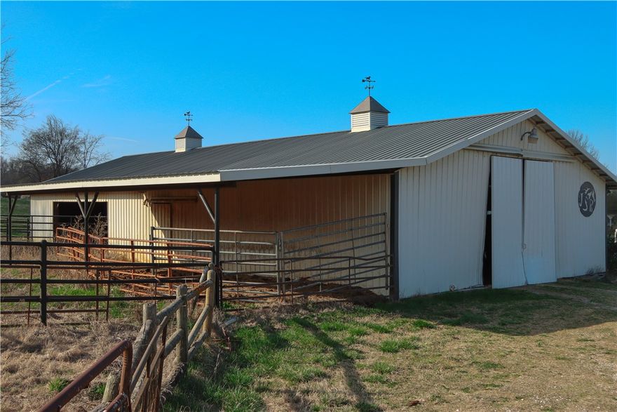 This tract has 3.01 acres with a metal barn with stalls and working pens. It has 2 level pastures plus a great place to build your new home if desired.  Gated private development. Paved road and Fayetteville city water to each tract. Perc test completed for a standard septic system. In area of nice homes.