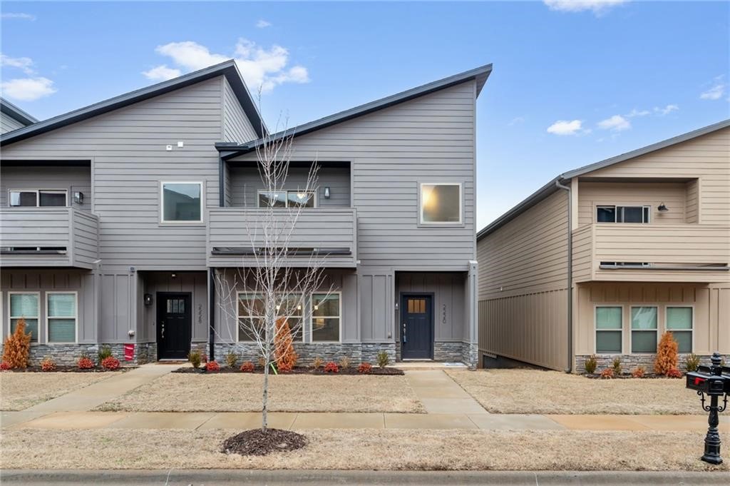 Gorgeous new construction townhome! Welcome to Timber Ridge Estates! This townhome is just minutes from the interstate & the University of Arkansas. This home has a gorgeous view from the upper balcony, granite counter tops, large closets, & a custom interior design! Perfect for long term rental, the split floor plan boasts 3 spacious bedrooms PLUS an office.