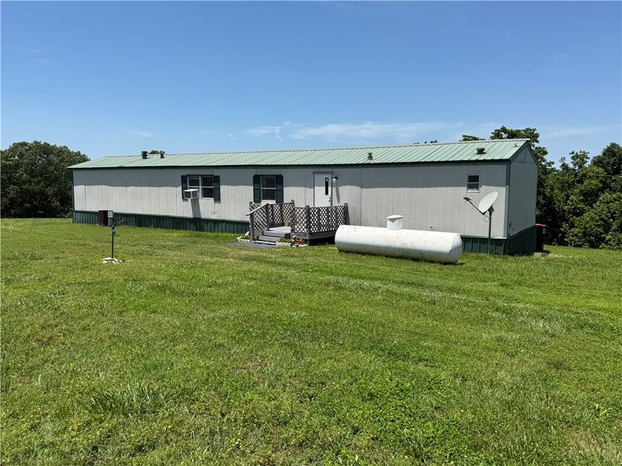 2 gorgeous acres!!! Beautiful views! 3 bedrooms 2 baths. Don't miss this opportunity to own your own space! Cute mobile. Large living room and it is open to the eat-in kitchen. Utility room. Primary bedroom has its own bathroom. Other bathroom is at the other end of the home along with 2 bedrooms. Huge deck with fabulous views.