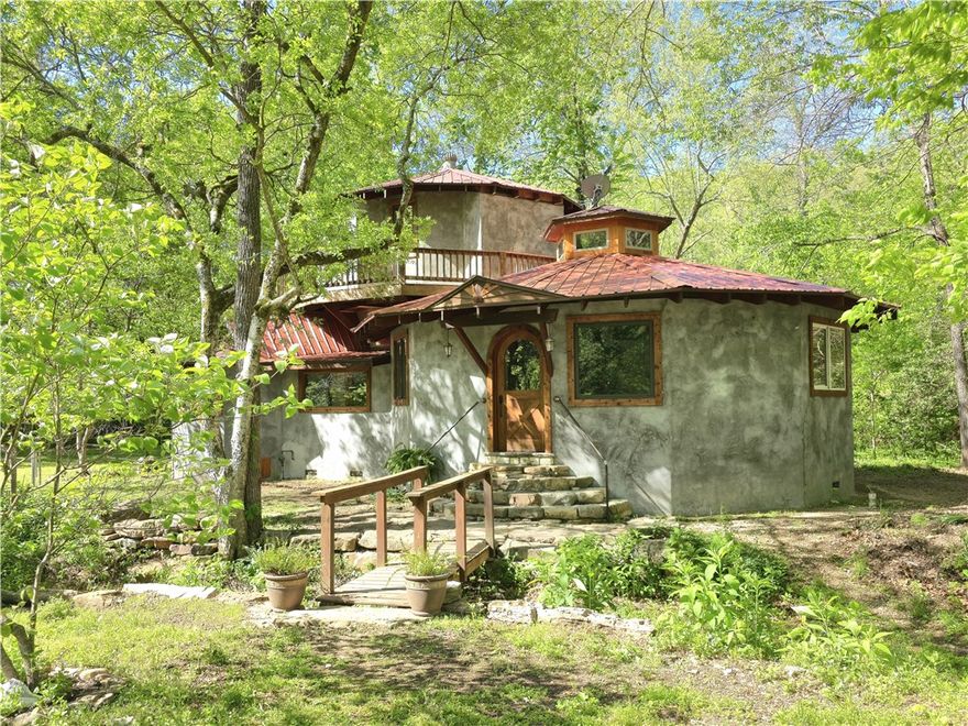 If you’re looking for privacy, sustainability, and the freedom to live life on your own terms—this Ozark homestead delivers. This one of a kind off grid home is a craftsman piece of art that is filled with custom finishes and details that have been thoughtfully designed to offer sustainability without giving up comfort. This 16-acre homestead offers freedom with no restrictions or easements, a deep water well into the Roubidoux (987 ft), a seasonal creek, numerous additional building sites, and is nestled at the end of a quiet county road that is located just a few miles from historic Eureka Springs.  Inside this amazing home you will find 3 bedrooms, 2 baths, an open concept living, dining, and kitchen, hickory hardwood floors and cabinets, custom tilework, large double pane windows, multiple heat sources, an active fan circulation system, and detailed woodwork throughout.  Upstairs, you will enjoy the wrap around deck that is perfect for watching wildlife by the creek. 48 volt solar system. Call for more details!