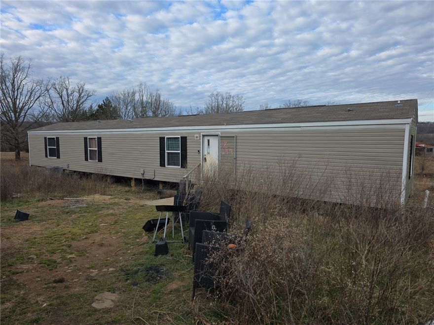 Come get a slice of country living! Mobile home on 1.8 acres tucked away just 10 minutes from town (Elkins). Single wide with 3 bedrooms and 2 bath. Large yard with lots of potential.