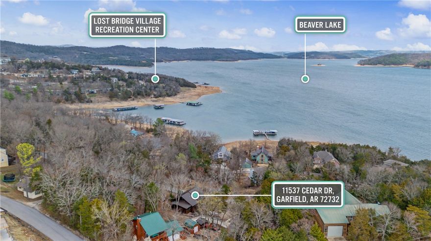 Lakeview cabin charm in Lost Bridge Village! This beautifully updated home features warm log-style siding and captures scenic views of Beaver Lake from the spacious back deck—perfect for relaxing mornings or sunset evenings overlooking the water. Inside, you’ll find rich hardwood flooring, a remodeled kitchen with granite countertops and stainless appliances, and an inviting living area centered around a native stone fireplace. The home offers a generous primary bedroom, two full baths, and cozy loft access with updated carpeting. The extended driveway provides valuable additional parking for guests, boats, or lake toys. Located just minutes from the water, this property offers the ideal blend of cabin character, comfort, and lake lifestyle.