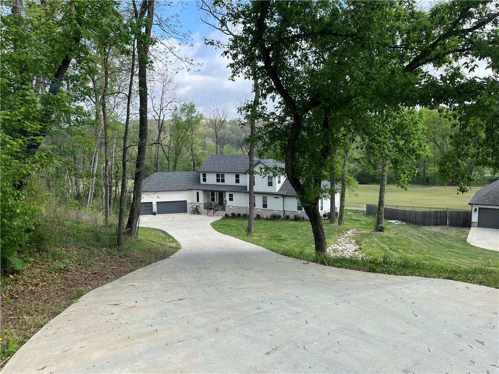 Sizzling Price! Back on the Market at No Fault of the Seller. Astonishing Big Sugar Creek Golf Front Home! Breathtaking views of the 1st hole fairway! Captivating .81-acre estate property. Dazzling 4-bedroom 3-bathroom 2- 2-level home, magnificent bonus room upstairs, spectacular open concept living room and kitchen, stylish granite counters and backsplash, gas top range, built-in microwave and oven, well designed hidden pantry, cozy gas fireplace, windows beam plenty of natural light into the living space, welcoming covered deck off living room, spacious master bedroom with lighted tray ceiling, striking master bathroom w/ full tiled shower & whirlpool tub, expansive master bedroom closet w/built-ins, (2) additional bedrooms downstairs comfortably sized, smart thermometer controls (2) HVAC units, extra-large 3-car garage w/ epoxy floors, fiber optic internet, Rogers School District, (Move In Ready), New Walmart offices less than 15 minutes away. Click on the Virtual Tour link to get 3D tour of home.