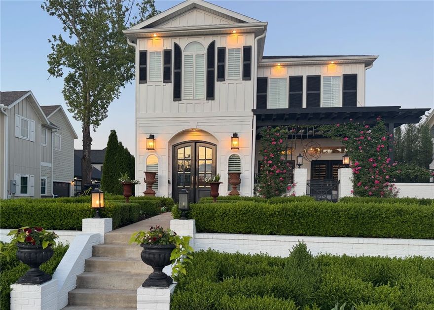 Luxury English Revival home in the heart of downtown Bentonville - just 4 blocks from the vibrant square.Minutes to The Momentary, new Walmart Home Office, Crystal Bridges, Schools, Airport & I49. This residence showcases marble countertops & marble & herringbone wood flooring, designer lighting, wallpaper & high-end finishes throughout.  Main level primary suite provides privacy & convenience with 3 bedrooms on second floor. A separate Studio Suite w/full kitchen & bath sits above the 2-car garage & has its own private entrance perfect for guests or rental income. You will be in awe of the 1800sf outdoor living space featuring a heated Gunite plunge pool, fire pit & gated courtyard w/ gas fireplace along with an over-the-top outdoor kitchen with granite countertops!  An entertainers dream!  The yard is professionally landscaped with a formal English Garden which recently WON BENTONVILLE'S YARD OF THE MONTH. Walkable to restaurants, trails, and shopping -  A rare opportunity to own a true downtown Bentonville icon.