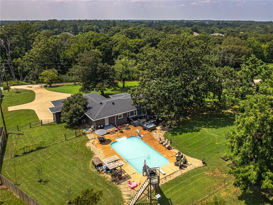 Prime Location: Bentonville Schools, Bentonville West HS, just 2 miles from I-49 and 8 miles from Downtown Bentonville! Welcome to this stunning 2,209 sq.ft. home boasting a bright, open floor plan! This property offers: Elegant built-ins, durable Pergo flooring, and brick/vinyl shake siding 3-car garage, and a cozy wood-burning fireplace with steel liner & blower Converted garage transformed into a versatile, climate-controlled space—ideal for a bonus room, gym, office, or additional bedroom Ample storage with a safe room/tornado shelter in Garage Large swimming pool, one of kind slide and hot tub Beautiful 1.02-acre lot with mature shade trees, gardening beds, fruit trees, porches, and decks Fully fenced with a well house (public water option available; owner enjoys abundant, high-quality well water) Unique Opportunity: Previously a highly successful Airbnb, consistently fully booked!