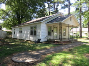 DELIGHTFUL DWELLING-- CLOSE TO THE UNIVERSITY! In very good condition, this well cared for cutie has newer laminate flooring, large kitchen w/ beautiful cabinets, plenty of closets, bonus room. Newer HWH. The exterior offers a carport, storm cellar, large fenced backyard. Fenced side deck makes a great dog run! Architectural shingles on roof.