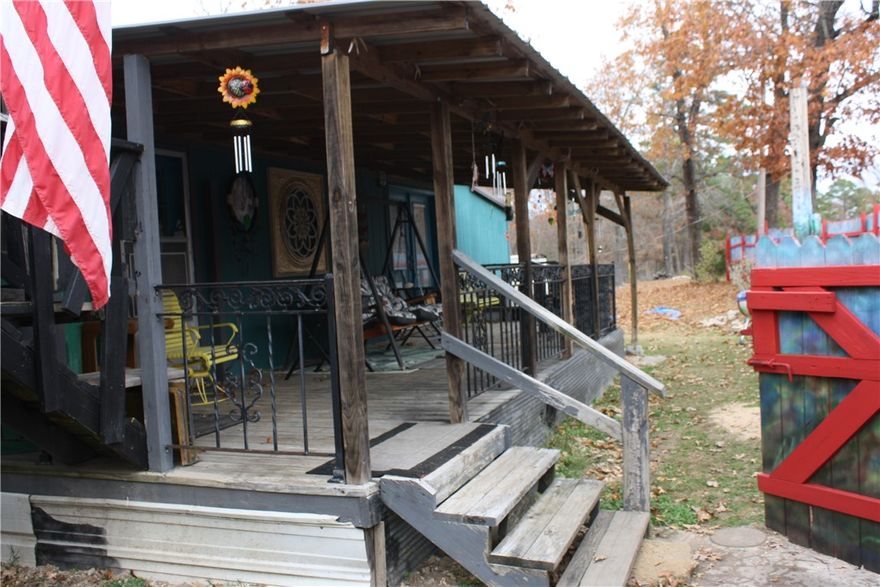 This 25.4 ac wooded land with a modest 3 Bd/1Ba cabin on county road 8001 is a perfect weekend get away or permanent home.  2 car carport and also an RV cover, several outbuildings for storage.  Land boasts several springs with wet weather creek, caves to explore, several old logging roads, flat spots to build your forever home with beautiful views. 2 hunting stands in place with shooting lanes. Access to Bull Shoals lake 20 min to end of  MC 8001. Adjoining 10 acres available to purchase also.  Selling AS IS WHERE AS