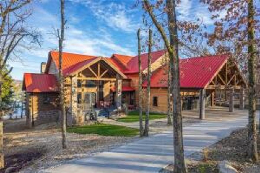 Where luxuary meets Rocky Mt. Lodge on Beaver Lake.  Just steps from the water. 2-slip PRIVATE BOAT DOCK w/solar panels, 2 lifts & swim platform.  New 30 x 24' shop that is heated & cooled.  Superior construction throughout on this impressive custom built home with lake views year round. Contains 2 master suites, 2 offices, 3 living areas, theatre room, game room, home gym. Butlers pantry. 4 fireplaces, heated travertine stone tile floor, covered decks. Whole house Generac & much more.