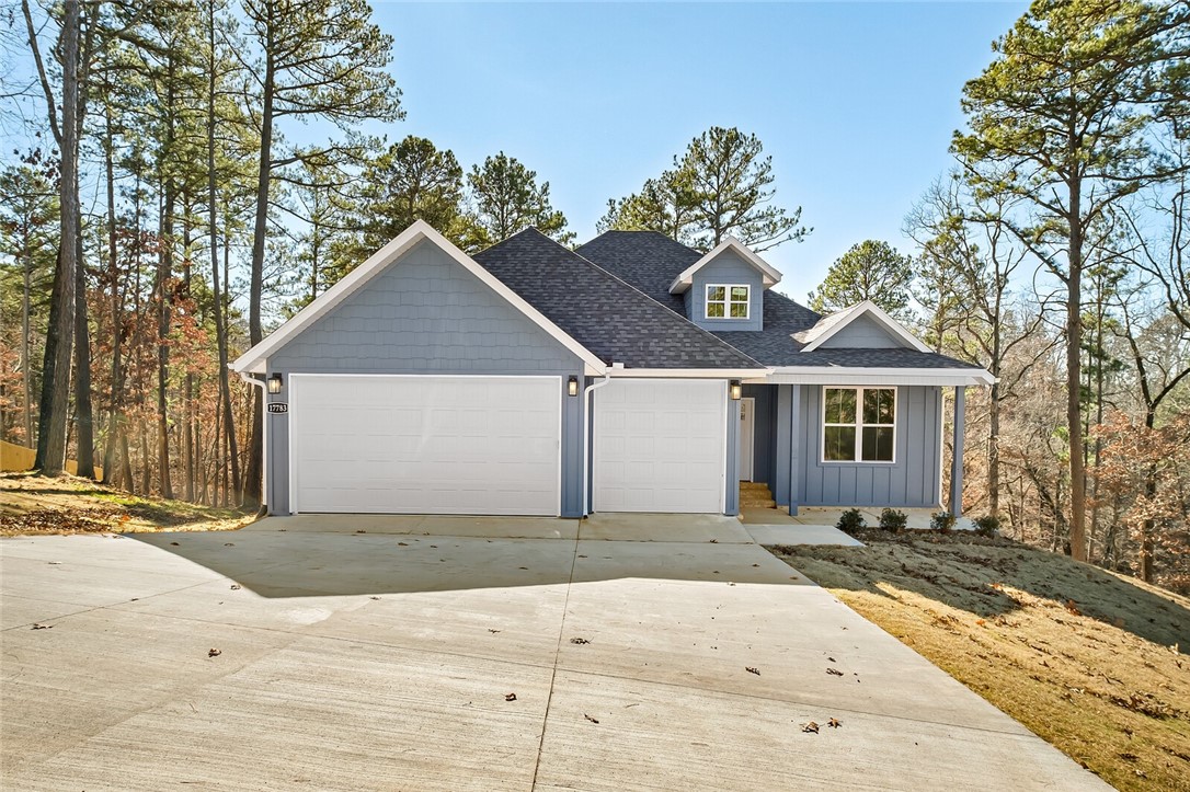 Come home to this Beaver Lake area property. This home features an open floor plan, hardwood flooring throughout, custom cabinets and trim work with lots of storage and cabinet space, an oversized 3 car garage, a finished walkout basement with a second living area and large bonus room, a covered deck with lots of privacy. Just around the corner from Prairie Creek Marina and just minutes from downtown Rogers. Move in today. The basement also features an unfinished space of 392 sq/ft that is not included in listed square footage.