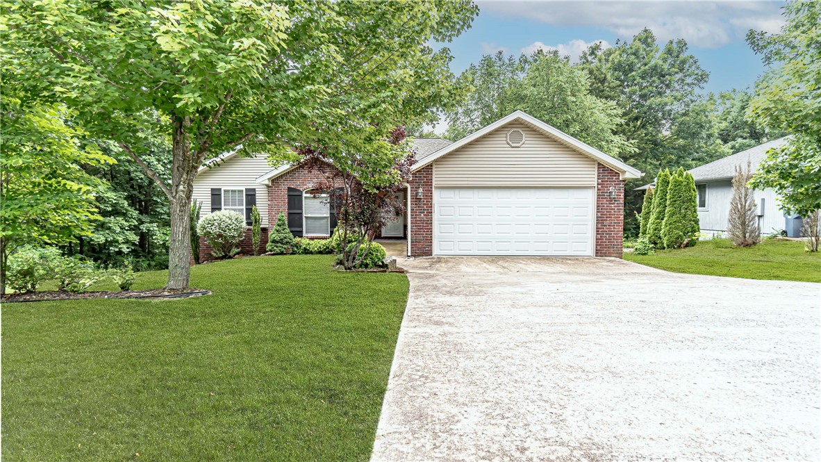 Cozy Bella Vista home. Living room features vaulted ceilings, cozy fireplace and hardwood floors. Kitchen has classic stained cabinets with granite countertops. Master bath has tiled shower with double vanity. Elevated back porch is great for viewing wildlife in your backyard oasis!