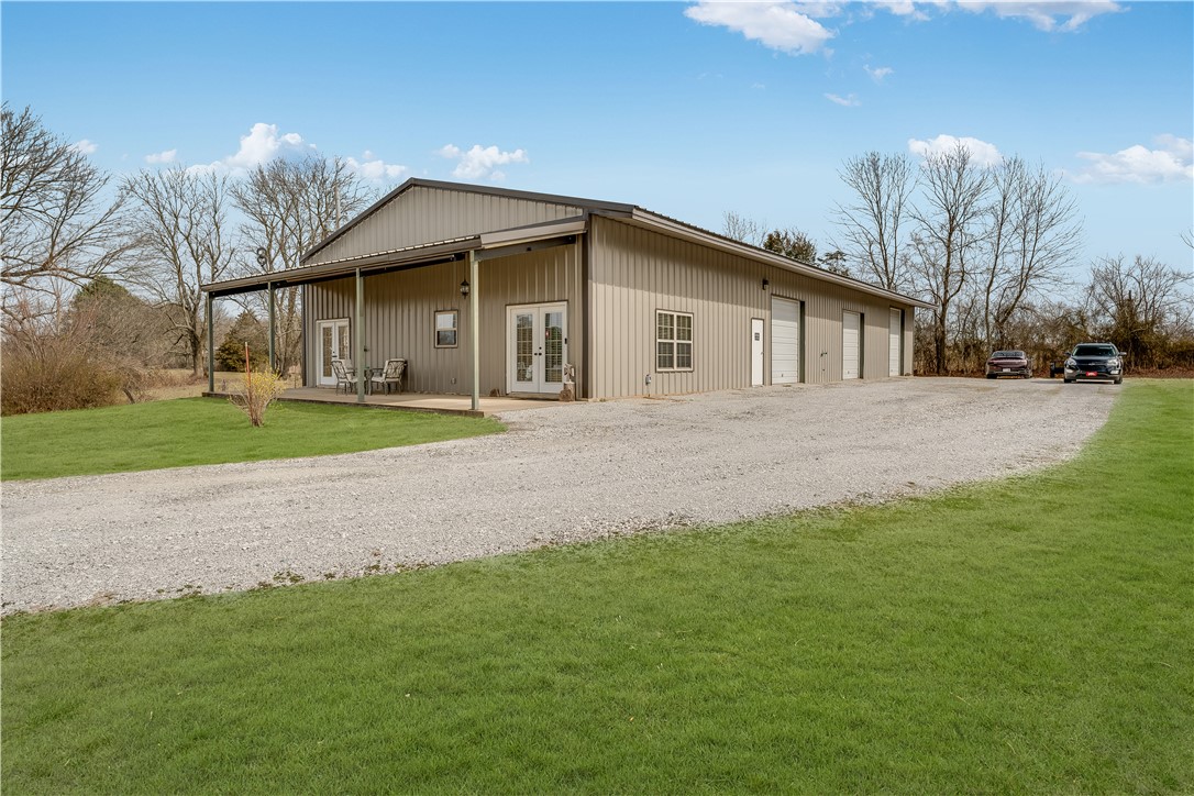 Welcome to this unique & meticulously maintained residence. This distinctive property, designed with durability and functionality in mind, offers an exceptional living experience on 4.9-acres and 40 x 100 Barndominium. Constructed with red iron & cross cable for strength & sturdiness. It features 12-inch thick concrete floors and walls, this house is a testament to quality and longevity. The home has an open floor plan, 2 cozy bedrooms & 2 bathrooms. For those who appreciate ample storage and workspace, this property features a loft area perfect for storing your belongings, as well as three bays with garage doors (one 12-foot and two 10-foot) that can accommodate a variety of projects or hobbies. For those car enthusiasts, the car lift conveys. 200 amp & 50 amp breakers. The HVAC system was replaced in 2018. Outside, the grounds offer a garden area for those with a green thumb, a pond and fenced area suitable for animals. Don't miss out on this wonderful property!