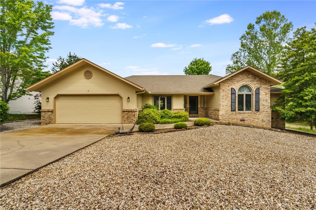 Charming Bella Vista Retreat Just Steps from Scotsdale Golf Course! Welcome to 12 Luncarty Lane – a tranquil 3-bedroom, 2-bath home perfectly positioned across the street from the Scotsdale Golf Course and just a block from the Scotsdale Bike Trailhead. This inviting retreat offers vaulted ceilings, an airy open layout, and a cozy fireplace that creates the perfect atmosphere for relaxation. The sunlit kitchen features generous counter space, a breakfast nook, and plenty of room to create your favorite meals. Step outside to a private deck with peaceful, wooded views – ideal for sipping your morning coffee or winding down after a long day. With golf, trails, and beautiful Bella Vista lakes all just minutes away, this home is a dream for nature lovers and outdoor enthusiasts alike. Whether you're seeking a full-time residence or a weekend escape, this gem offers the perfect blend of comfort, convenience, and Ozark charm. Don't miss your opportunity to own this slice of Bella Vista beauty!