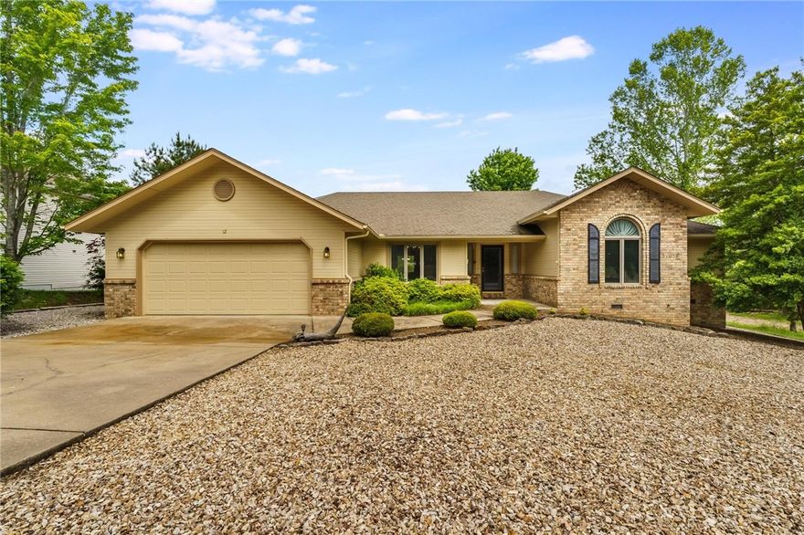 Charming Bella Vista Retreat Just Steps from Scotsdale Golf Course! Welcome to 12 Luncarty Lane – a tranquil 3-bedroom, 2-bath home perfectly positioned across the street from the Scotsdale Golf Course and just a block from the Scotsdale Bike Trailhead. This inviting retreat offers vaulted ceilings, an airy open layout, and a cozy fireplace that creates the perfect atmosphere for relaxation. The sunlit kitchen features generous counter space, a breakfast nook, and plenty of room to create your favorite meals. Step outside to a private deck with peaceful, wooded views – ideal for sipping your morning coffee or winding down after a long day.  With golf, trails, and beautiful Bella Vista lakes all just minutes away, this home is a dream for nature lovers and outdoor enthusiasts alike. Whether you're seeking a full-time residence or a weekend escape, this gem offers the perfect blend of comfort, convenience, and Ozark charm. Don't miss your opportunity to own this slice of Bella Vista beauty!