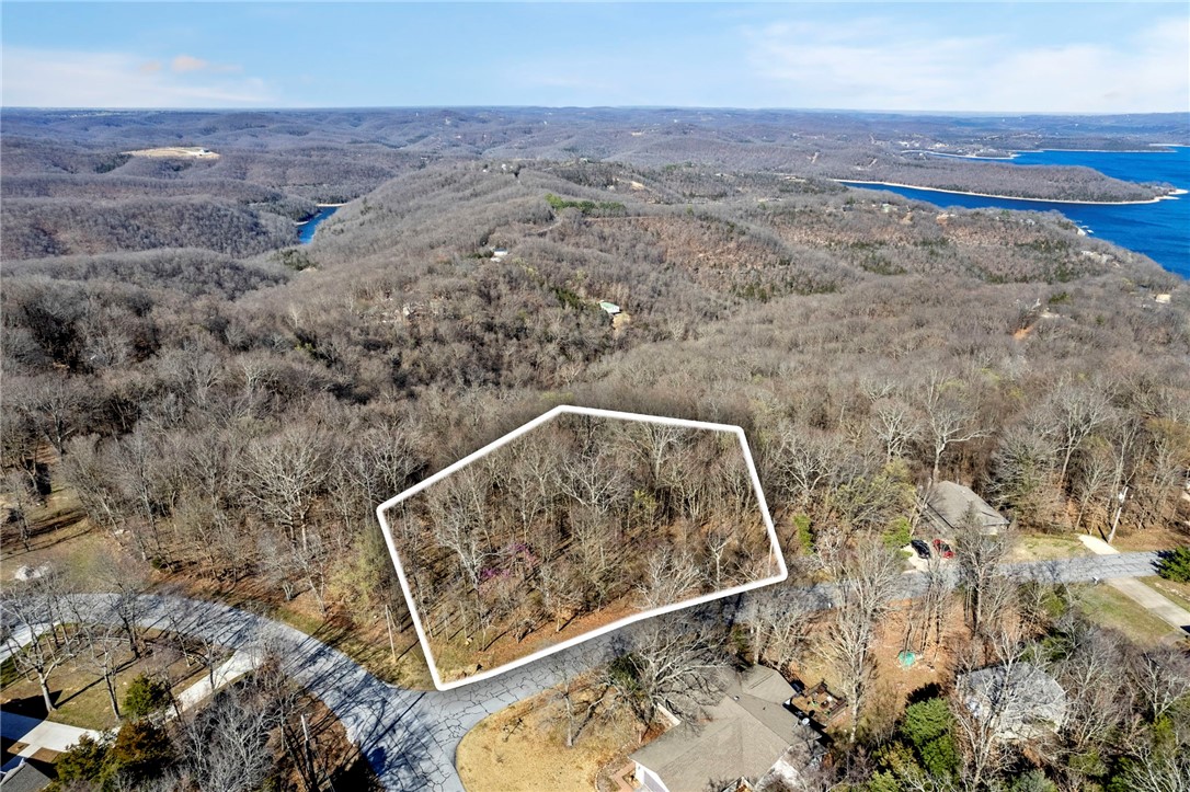 Rare Double Lot with Scenic Views on Whitney Mountain.
Donāt miss this double lot on the view side of Timberline Drive atop picturesque Whitney Mountain! Spanning over half an acre (.53 acres), this unique property offers a versatile mix of flat terrain in the frontāideal for easy constructionāand a sloped rear that give you the perfect setting for a walk-out basement and minimal maintenance - no mowing.
Imagine designing your perfect lake retreat with utilities already at the street, saving you time and money. Use those savings to build a show-stopping deck to soak in sweeping seasonal views of Beaver Lake and the serene beauty of the Ozark hillside.
Located in the sought-after Lost Bridge Village, youāll enjoy access to top-tier amenities: a recreation center, swimming pool, tennis courts, library, meeting rooms, and even a private airstrip. Whether youāre ready to build now or planning for the future, this is your chance to secure one of the most desirable remaining lots in the area. Call Now!!