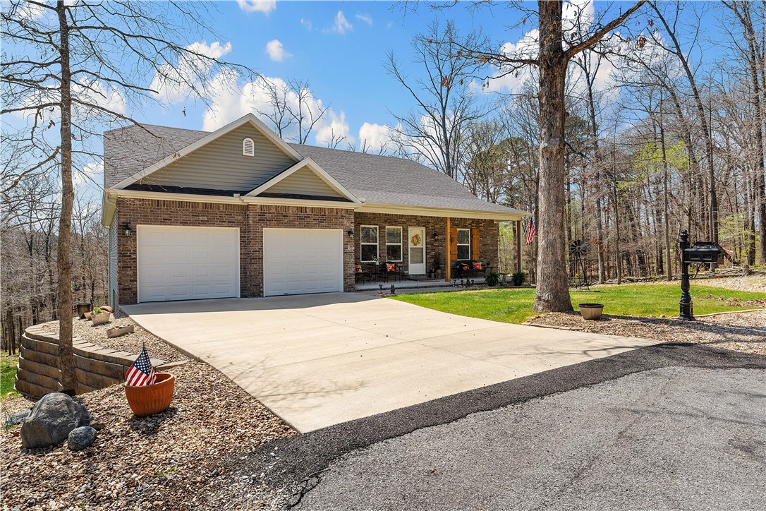 Impeccably clean? Check. Stunning views from the back deck overlooking a large lot? Check. Split floor plan? Check. This home checks all the boxes and is sure to impress. Also, unlike many homes in Bella Vista that rely on septic systems, this one is connected to the city sewer.
Tucked away at the end of a quiet cul-de-sac, this home welcomes you with a charming front porch & a beautifully manicured yard, making a fantastic first impression. As you step inside, you'll be greeted by a spacious, open-concept layout filled with natural light. The split floor plan ensures privacy, with the primary suite located on one side of the home and two additional bedrooms on the other.
The real highlight is the back porch, offering an incredible space to relax and enjoy the view. The property backs up to Bella Vista POA land, and the current owners have put in the effort to transform the lot into a serene, park-like setting. This home has been cherished and well loved! Ask for the virtual tour link or schedule a showing today!