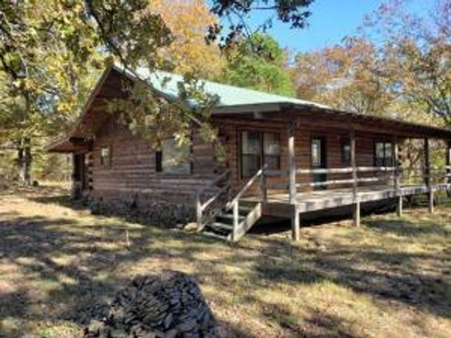 Cute log home sitting on 20 acres more/less; short distance off pavement; large covered porches; metal roof; located in beautiful Ozark Mountains; not too far to the Buffalo River; can use as a cabin or permanent home