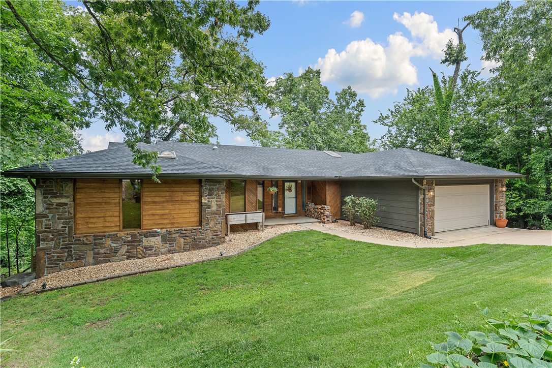Beautifully remodeled home in quiet neighborhood. Close proximity to biking trails, Empty lots on both sides of property which gives you a more private setting, Beautiful Knotty Alder stained countertops. New Architectural Shingle roof, 3BR, 3.5BA. Great floor plan with 1 bed and bath in basement, could be used as a mother-in-law suite. Fireplaces have blower system integrated into ducts that move heat through home, Heated and cooled 400 sq ft workshop in basement with outside access. Easy access to I-49, Beautiful landscaping……come see your next home!