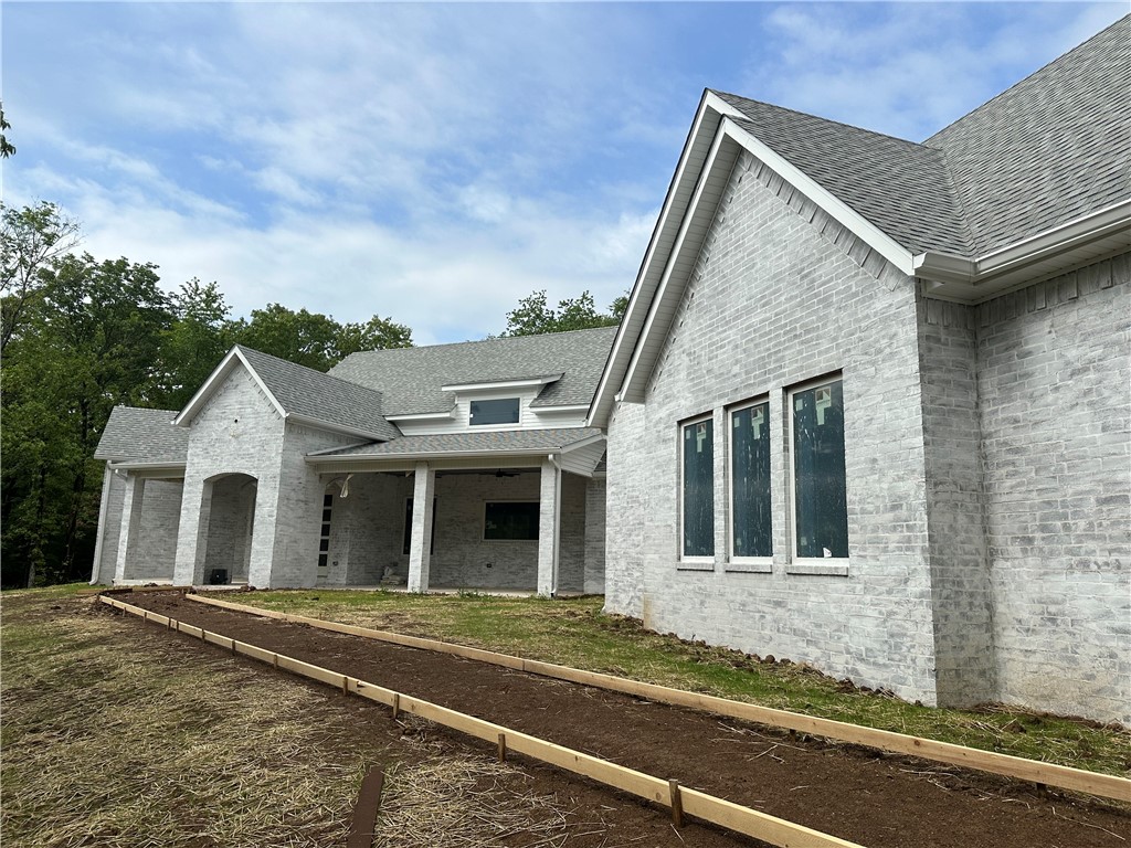 BRAND NEW!! STUNNING CUSTOM BUILT HOME! Nestled hillside on 5 acres just minutes from historic downtown Prairie Grove, this 4434 square foot delight is waiting for you! Boasting 5 bedrooms, 5.5 baths it has room for everyone. All bedrooms have attached custom tiled bath areas. Gorgeous kitchen built with entertaining in mind. A large island overlooks the living area which boasts beautiful glass sliding doors giving you access to a massive covered outdoor living space. This beautiful arched covered patio is ready for your dream outdoor kitchen and grilling space. Just steps beyond the patio you will find a 1/2 acre pond. This outdoor dream is also accessed from an expansive master bedroom and bath area complete with 2 spacious walk-in closets. Multiple laundry connections throughout the home. A perfectly set office/workout room gives you picturesque views while working. This home is full of the modern features, fixtures and designs that you don't want to miss! More pictures coming soon! Schedule your showing TODAY!