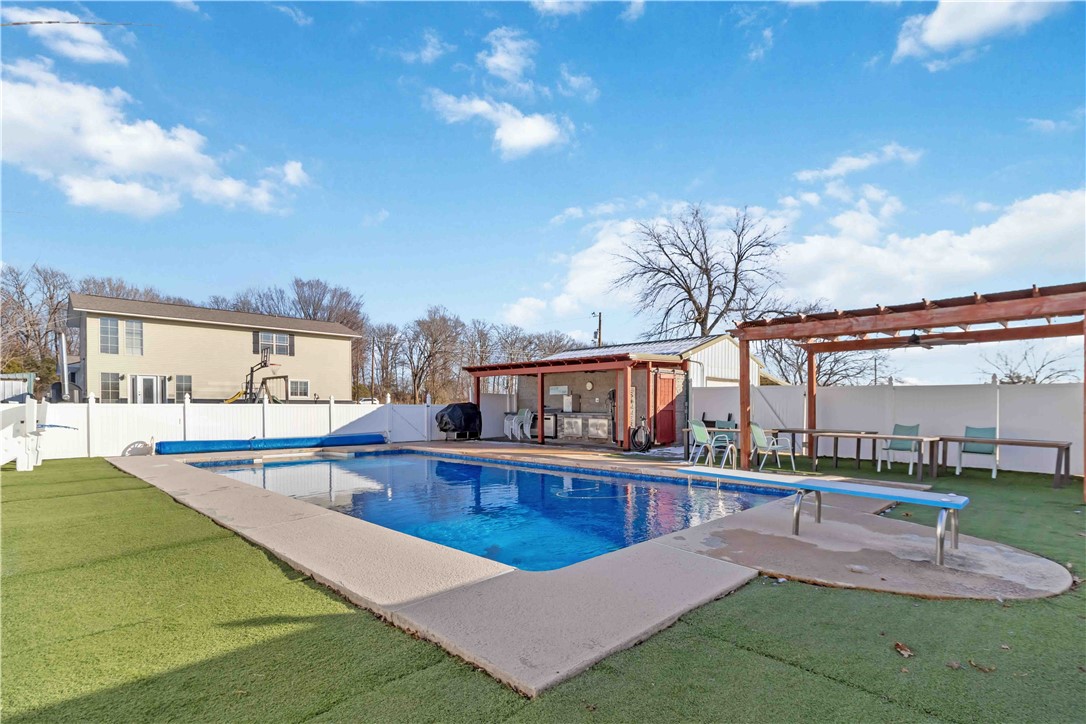 Welcome home to this charming and versatile property, where modern updates meet timeless country character. Step onto the inviting front porch and into a spacious living room, perfect for gatherings and cozy evenings.
The backyard oasis features an 18’x36’ saltwater pool, outdoor kitchen, and gazebo—all privately enclosed by a vinyl fence. Inside, the Master Suite boasts serene backyard views and a remodeled bath with a soaker tub and walk-in shower.
Two additional bedrooms include a built-in library and a guest-friendly Murphy Bed. The eat-in kitchen is a chef’s dream, highlighted by a custom epoxy countertop island, while the adjacent family room flows into a spacious backyard, perfect for endless activities.
Nestled near gravel cycling trails, I-49, this home offers both convenience and tranquility.
Serene, inviting, and perfectly located—this home has it all. $6,000 preferred lender credit towards lending closing costs or rate buy-down using Momentum Loans.