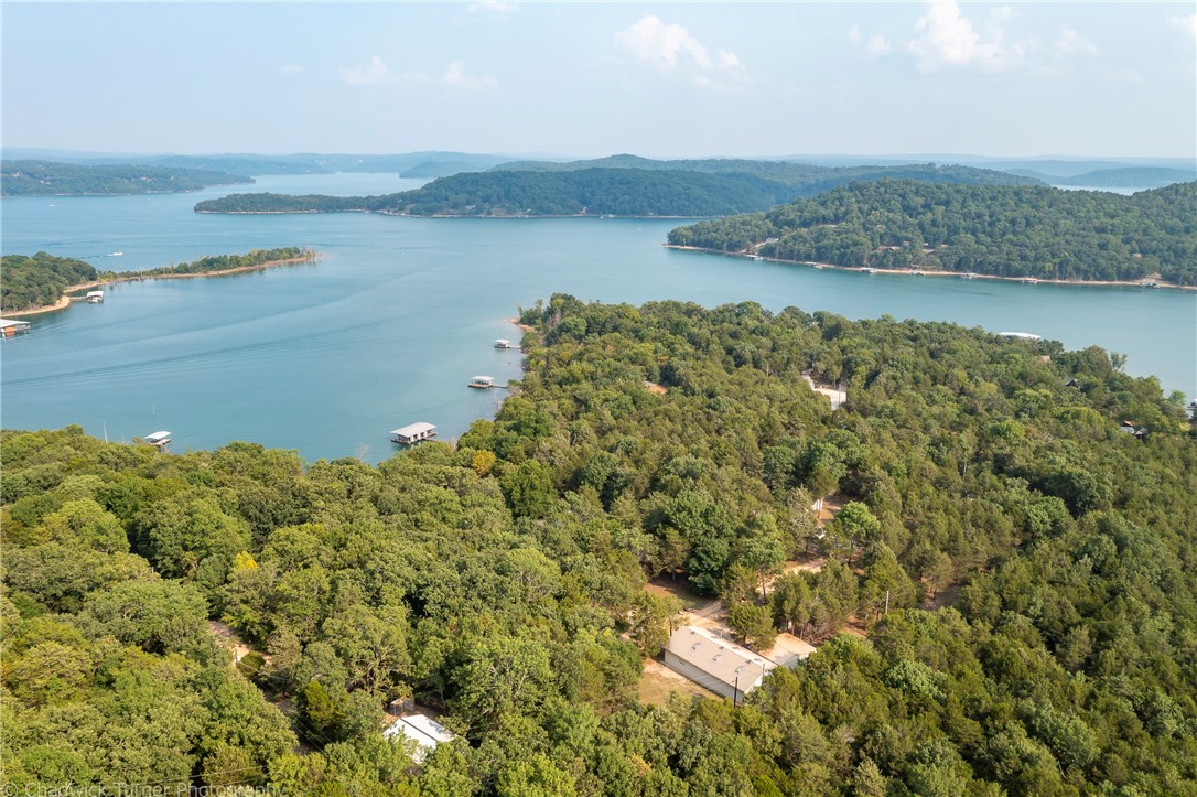 INVESTMENT PROPERTY! Handi-cap accesible. Extra lot has well and septic to build your home on. Need some elbow room and fresh air? Want to entertain your family and friends? It's all right here! One of a kind lake home. Talk about a secret hideaway, this place is it. Perfect lakefront home with huge storage building for all of your lake toys. 3 bedrooms 2 baths huge warehouse with fans and wood stove.
Level walk to your very own 2 slips with lifts and 3 lockers in a co-owned dock out your back door with an easy walk. It doesn't get much better. Beautiful home with tons of storage. Sitting on over 2 acres of pure heaven. Plenty of elbow room and space to entertain. Time to make some memories! Extra lakefront lot with well and septic with shower.
