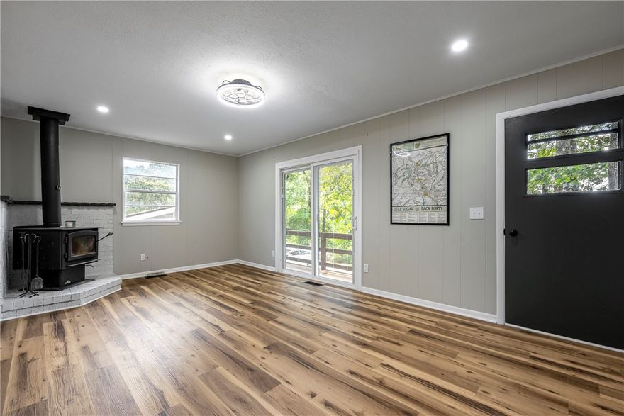 Back on the market at no fault to the seller. Imagine waking up with your morning coffee on the front porch, the sound of birds all around, & grabbing your bike for a quick ride—Play Thru trail is less than 1min away. Spend your afternoon kayaking on Lake Avalon or golfing at the Country Club, both just around the corner. When the day winds down, return home to your updated retreat with granite countertops, new flooring, & the cozy glow of a wood stove. With 2 bedrooms, 1.5 bathrooms, a single-car garage, & every detail refreshed—from the roof repair to the LED lighting—this efficient, turn-key home maximizes every inch. Enjoy your slice of the Natural State from your back deck surrounded by mature trees after a day of exploring. Nestled in a quiet location, you’re close to the new OZ Trails MTB park being built, restaurants, the library, & all the essentials. Easy highway access means you’re minutes from all of NWA or even Missouri. Adventure, comfort, & convenience all start here at 3 Boyce Drive.