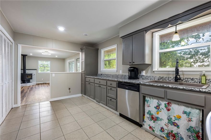 Back on the market at no fault to the seller. Imagine waking up with your morning coffee on the front porch, the sound of birds all around, & grabbing your bike for a quick ride—Play Thru trail is less than 1min away. Spend your afternoon kayaking on Lake Avalon or golfing at the Country Club, both just around the corner. When the day winds down, return home to your updated retreat with granite countertops, new flooring, & the cozy glow of a wood stove. With 2 bedrooms, 1.5 bathrooms, a single-car garage, & every detail refreshed—from the roof repair to the LED lighting—this efficient, turn-key home maximizes every inch. Enjoy your slice of the Natural State from your back deck surrounded by mature trees after a day of exploring. Nestled in a quiet location, you’re close to the new OZ Trails MTB park being built, restaurants, the library, & all the essentials. Easy highway access means you’re minutes from all of NWA or even Missouri. Adventure, comfort, & convenience all start here at 3 Boyce Drive.