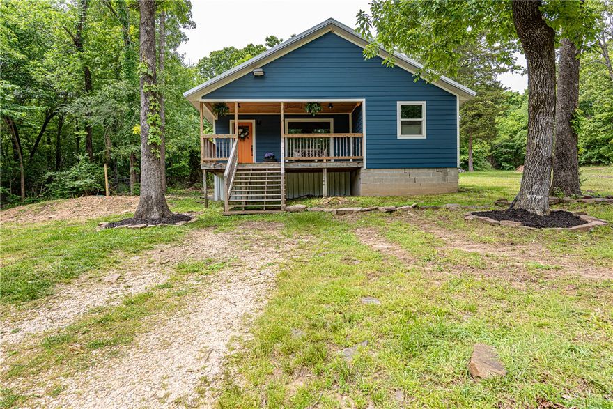 WELCOME HOME! This 3 bedroom 2 bathroom home on 2 acres +/ - is what you've been looking for to plant your roots! Located a short drive from Downtown Prairie Grove, City of Lincoln, I-49, & Fayetteville, this property offers both privacy & convenience. From the covered front deck head in to the living area w: vinyl plank floors, vaulted ceiling w/ wood detail & beams, large picture window, & wood stove! An eat in dining leads to the U-Shaped kitchen w/ butcher block counters, s.s appl, gas range, white apron sink, & stylish green cabinetry! A small flex space nearby perfect for coffee nook/ drop zone. Relax in the primary suite w/ private ensuite! Enjoy an addtl. two beds & one bath! Upstairs a loft space w/ vinyl plank floor, mini split, & closet for add’tl storage! Head out to the large partially cleared yard w/ mature trees, & storage building offering plenty of room to enjoy the outdoors! Bonus - NEW Septic System! Act now!