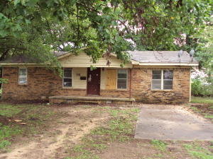 Over 1200 square foot brick and vinyl home with porch, patio, and needing repairs. Repair and reap the benefits.