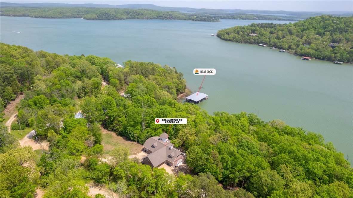 Gorgeous Beaver Lake Front Home w/2 Boats Slips on Private Co-Owned Dock! Home has been fully renovated & comes fully furnished, great turn-key investment opportunity! Located on 0.96 AC w/341 ft of shore access. You are welcomed in by beautiful views from the floor to ceiling windows in living space. Spacious living room has fireplace & surrounding built-ins, vaulted ceilings & access to deck via multiple sliding glass doors for amazing views. Kitchen boasts great amenities for entertaining, including island w/prep sink, double ovens & gas range! Sunroom is great additional living space to enjoy lake views. Primary suite on main level w/deck access, en-suite w/soaking tub, spacious shower &WIC. Main level also has Guest room w/attached bath. Lower level has 2nd living area w/wet bar & fireplace. 2 guest rooms w/their own private baths. 2nd laundry room w/access to the 2 car garage. Covered patio for more outdoor living space & easy access to lakeshore. 2 slips on co-owned dock, one w/2021 hydro lift.