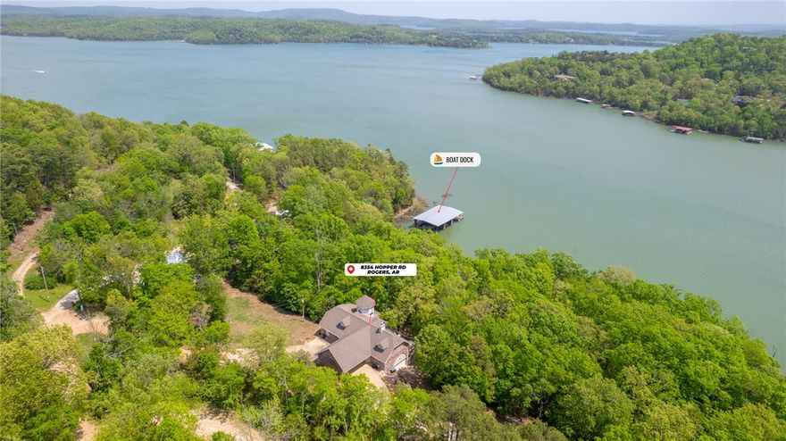 Gorgeous Beaver Lake Front Home w/2 Boats Slips on Private Co-Owned Dock! Home has been fully renovated & comes fully furnished, great turn-key investment opportunity! Located on 0.96 AC w/341 ft of shore access. You are welcomed in by beautiful views from the floor to ceiling windows in living space. Spacious living room has fireplace & surrounding built-ins, vaulted ceilings & access to deck via multiple sliding glass doors for amazing views. Kitchen boasts great amenities for entertaining, including island w/prep sink, double ovens & gas range! Sunroom is great additional living space to enjoy lake views. Primary suite on main level w/deck access, en-suite w/soaking tub, spacious shower &WIC.  Main level also has Guest room w/attached bath. Lower level has 2nd living area w/wet bar & fireplace. 2 guest rooms w/their own private baths. 2nd laundry room w/access to the 2 car garage. Covered patio for more outdoor living space & easy access to lakeshore. 2 slips on co-owned dock, one w/2021 hydro lift.