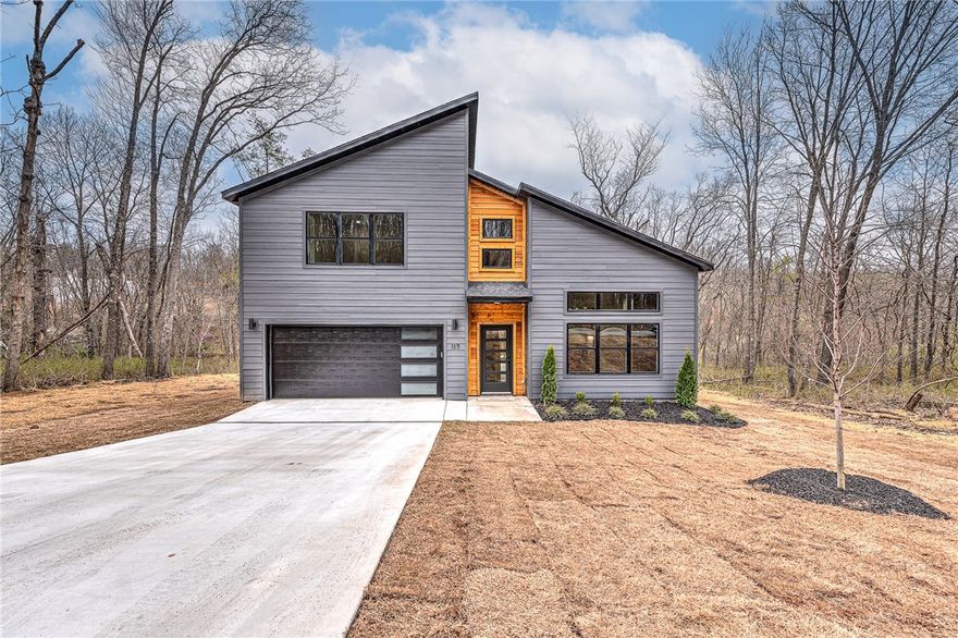 Don’t miss this opportunity to own a stunning modern new construction home priced to sell before completion!  The beautifully designed 2-story home features 2 bedrooms + office w/ closet and 2.5 baths.  Walk inside to an open floor plan with soaring, vaulted ceilings, offering tons of natural light into the living room and kitchen.  Featuring hardwood flooring throughout the first floor, custom kitchen cabinets and island, upgraded appliances, modern lighting and high end quality finishes. The first floor primary suite has a spa like bath with double vanities, custom tile shower, soaker tub and walk-in closet.  Upstairs you will find the second bedroom and third bedroom or office w/ closet.  All of this is located minutes to Lake Lomond, trails, golf courses, and the extensive amenities Bella Vista has to offer!  House is under construction with an est. completion date is 7/1/25.  Pictures are of similar house and finishes.