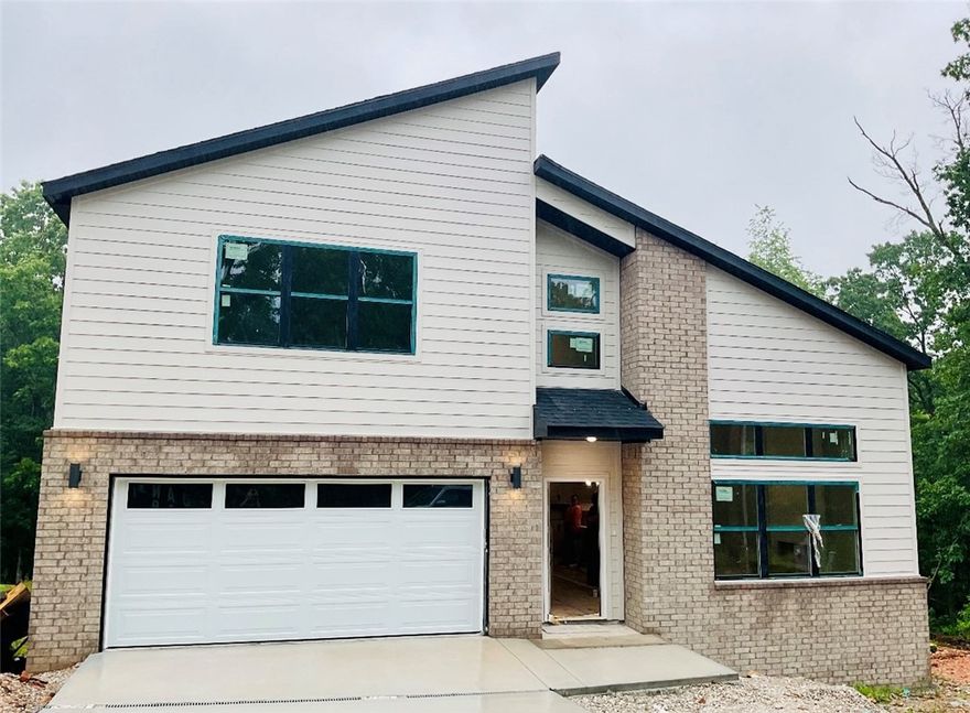 Don’t miss this opportunity to own a stunning modern new construction home priced to sell before completion!  The beautifully designed 2-story home features 2 bedrooms + office w/ closet and 2.5 baths.  Walk inside to an open floor plan with soaring, vaulted ceilings, offering tons of natural light into the living room and kitchen.  Featuring hardwood flooring throughout the first floor, custom kitchen cabinets and island, upgraded appliances, modern lighting and high end quality finishes. The first floor primary suite has a spa like bath with double vanities, custom tile shower, soaker tub and walk-in closet.  Upstairs you will find the second bedroom and third bedroom or office w/ closet.  All of this is located minutes to Lake Lomond, trails, golf courses, and the extensive amenities Bella Vista has to offer!  House is under construction with an est. completion date is 7/1/25.  Pictures are of similar house and finishes.
