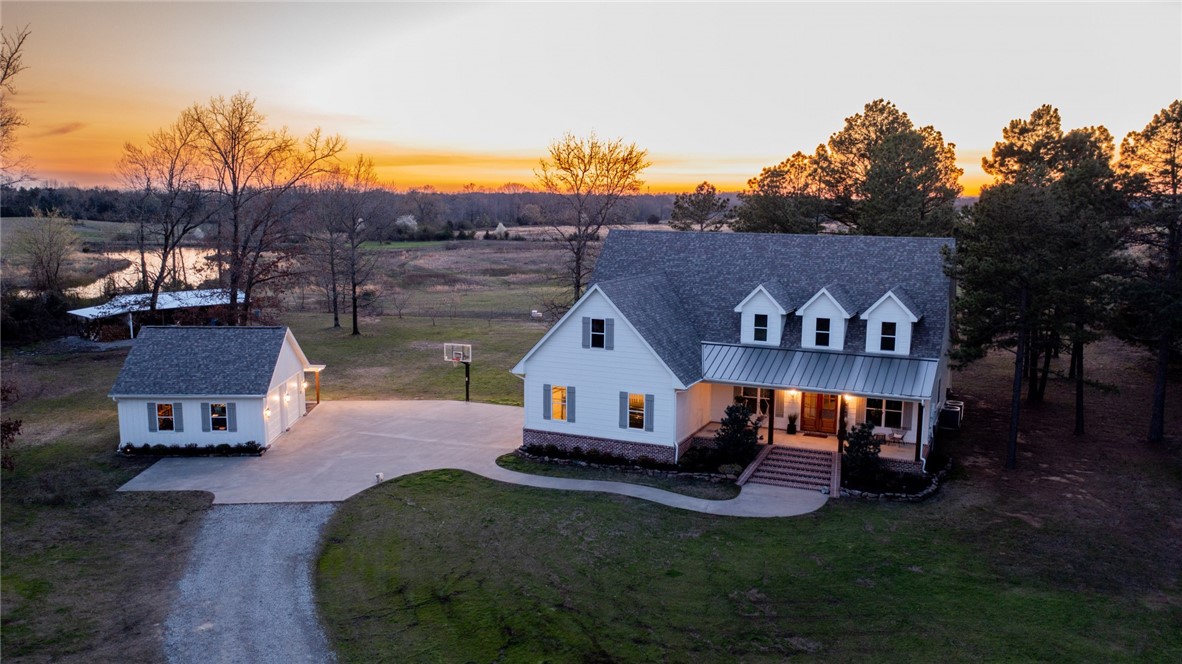 BEAUTIFUL one home and 5.23 acre property. It truly is one of a kind. Privacy, acreage, amazing sunsets, stocked pond and dock, detached shop, barn with chicken coop, and raised garden beds. A great property to enjoy the country and wildlife from.This high efficiency home has a beautiful open floor plan great for entertaining. 3 master suites, additional upstairs living room, exercise room, sunroom, wood burning fireplace and so much more.This property is located just north of Alma.