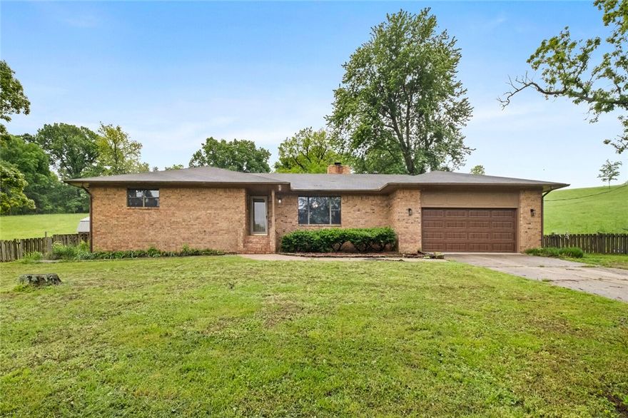 NEW ROOF/5 year warranty transfers to Buyer/small acreage (just shy of 3 ac mol) to call home! Only a short distance to all NWA has to offer: 15-20 min to JBU,30 min to Bentonville or Fayetteville! Right in the Tontitown growth realm! This home boast of 3 BR/2.5 BA with great updates: Primary suite has a new walk-in shower, new exterior/interior lighting fixtures, wood burning stove (cleaned out May '25), fenced entirety for livestock! Chicken coop w/ nesting boxes & run. Livestock barn w/ lean-to and stalls (this is roughly 300 SF), LOTS of storage in the oversized garage w/ work bench, 2 closets for storage & floor to ceiling storage cabinets, Also the outside covered porch, resent painting, fenced backyard! Anyone looking for a great alternative option to the city hustle and bustle should consider this as a great opportunity! This property also has the storm shelter already installed AND a spring fed POND! Septic was pumped in '24, also water has a new pressure reg. valve. A PLACE TO CALL HOME IN NWA! NEW ROOF!