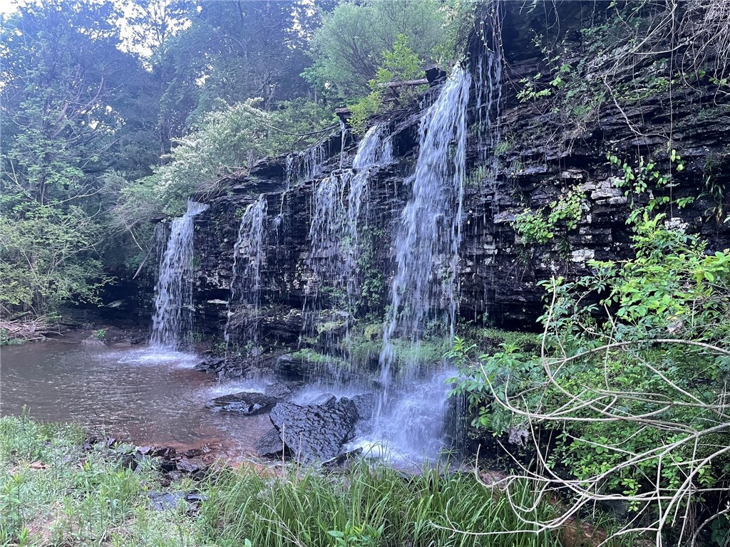 Escape to the Ozarks with this rare opportunity to own 218 acres of natural beauty at Lost Trails Ranch. This turnkey property blends serene wilderness with modern comfort, featuring miles of private trails, a spring-fed lake, creeks, and a stunning waterfall.
The ranch includes four fully equipped lodges—Fireside, Foothills, Foxhaven, and Bearclaw Lodge. It also features a administrative building and gym with a stage area. Designed for both personal enjoyment and income potential, it’s ideal for weddings, retreats, and events.
Recreation abounds with hiking, biking, kayaking, and wildlife watching across varied terrain from pine forests to open meadows. Outdoor living areas, firepits, and large dining spaces make it perfect for gatherings.
Located near Mulberry and within 2 hours of major airports, Lost Trails Ranch offers seclusion with accessibility. Whether you're looking for a private escape, a retreat center, or an investment, this property delivers.
Visit losttrailsranch.com to learn more.