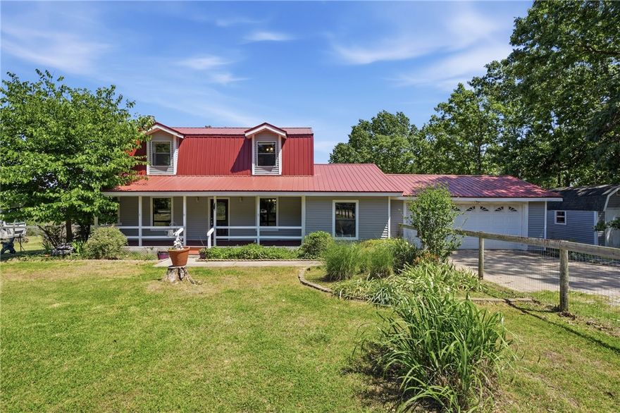 Home on 5.73 acres located just 10 minutes from downtown Eureka Springs! The property is fully fenced and cross-fenced,making it a perfect "horse property". The kitchen, features matching black appliances and refined granite counters. The living room provides a welcoming atmosphere, distinguished by its vinyl plank flooring and wood stove for added character.This property encompasses 2 well-appointed BR (with potential for a 3rd BR) and 2 full BA. Outdoor living is exceptionally catered to with a huge fenced private front and side yard, a massive deck ideal for entertaining, and a charming porch beneath the distinctive gambrel roof. Additional features include a whole-house generator and its own private well, a 1,500 sq. ft. barn/ large shop area for the "Toys" carport, two storage buildings, and RV-Boat storage with septic hookup, electric, and water. Move-in ready with room to enjoy both indoor and outdoor living. We invite you to experience the refined comfort and thoughtful design of this exceptional property.