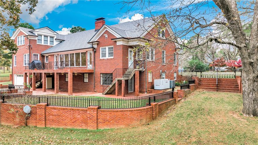 Great location in the quaint and beautiful Free Ferry Heights subdivision.  Near hospitals, restaurants, & shopping.  This home is a must see to take in all of the grandeur it offers and it's approx 6520 sq feet!  It is built of the finest high end finishes and extras!  As you tour the home notice the copper gutters & downspouts, beautiful iron work gates and fencing as well as the private brick fencing.  Also, notice the special finishes of custom millwork throughout the home, granite floors, marble and stone fireplaces, tiled garage, generator, custom built-ins, safe room, & more! The home boasts several gathering rooms including two large living rooms, theater room, library, bonus room, dining, & kitchen.  The living and dining rooms carry a European Elegance with the beautiful, custom millwork and marble surround fireplace.  The den has beautiful granite flooring, floor to ceiling stonework surrounding the beautiful fireplace.  All 3 bedrooms are exceptionally large with 2 of these bedrooms being large suites!