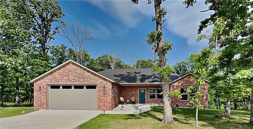 Enjoy the wooded view from the back deck of this gorgeous like-new home! This well maintained home is spread over two lots with mature trees giving you ample room and privacy. With tons of windows and a modern color palette you will love the bright and inviting space as you enter the home. The open living space has durable luxury vinyl plank floors and an airy chef's kitchen with gorgeous granite, plenty of cabinets and a pantry. This split layout home also includes a half bath that is perfect for guests. Storage is no issue as this home has lots of closet space. Step outside to the low-maintenance composite deck, protected by gutters with leaf guards, and enjoy the serene forest backdrop. The front porch offers a charming spot for morning coffee. The spacious, insulated 2-car garage comes with an electric vehicle outlet. Combining modern efficiency with a peaceful double-lot setting, this move-in ready home is truly a sanctuary. View the virtual tour now and then schedule your in-person showing! (2-bed septic)