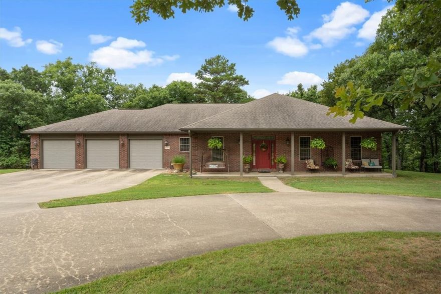 This beautiful home sits in a clearing on 11.71 wooded acres located in a peaceful, country setting less than a mile from the city limits.   The 4025 sq ft home features a split bedroom floor plan and three car garage on the ground level.  The kitchen boasts plenty of cabinets, a pantry and an eat-in kitchen area that is open to the living room.  There is a formal dining room, a dedicated office with built-ins and the centrally located living room has a wood burning fireplace.  The updated primary suite bathroom features a large soaking tub and a wonderful, oversized walk-in shower.  The partially covered, balcony-like deck out the back is a beautiful living space of its own.  The full walk-out basement is an entertainerās dream.  A wet bar, sitting area, game room, storage room, hobby area, full bath and a bonus room with closet are the highlighted rooms. 3 Heat/AC systems plus the fireplace has ductwork through the house as well.  Schedule your private tour of this stunning home soon.