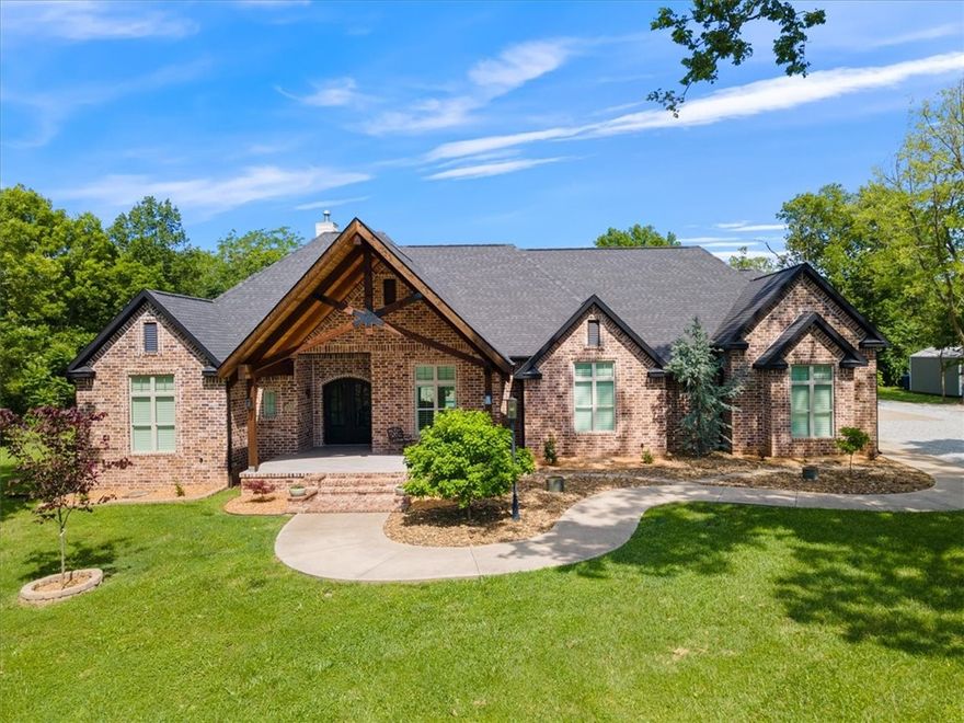 Custom built beauty centrally located in Siloam Sprs. Home is 4,000 sqft on the main level with 5 bedrooms and 4.5 bathrooms. 4 of the bedrooms on the main floor are en suite. Large in ground gunite pool with LED light features, fountain and bubblers. Jenn air appliances, central vacuum has 2 hide-a-hose to cover the whole house. Programmable smart lightening, garage openers, thermostats, lock all pair well with the whole house audio system and the surround sound. 1 room on the main level could be used a bedroom but has been used as a media room/workout room. Full brick makes for a low maintenance ext. Big 46' x 26' garage can fit 4 cars in the garage and the garage is where the large inground shelter is. The upstairs "bonus room" has a separate entrance from the outside and has a whole apt. It is 2/1 with full size kitchen, bathroom, storage and laundry. Has been used a rental and mother in law suite. Many upgrades throughout the house. Elaborate lighting package​​‌​​​​‌​‌​​​‌‌​​​‌‌‌​​‌​​‌‌​​​​ design.