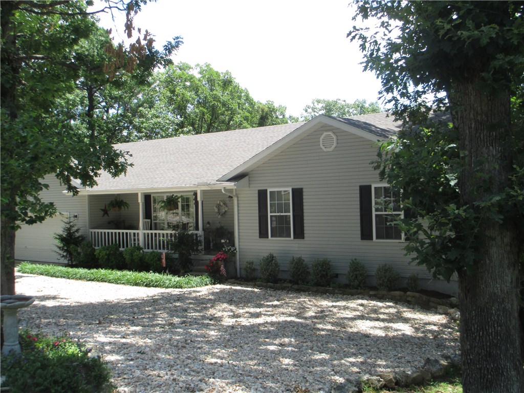 Home truly reflects pride of ownership. Meticulously maintained & beautifully updated.Hardwood floors, granite counters throughout, tile shower, tons of storage space, great back deck to take in the mountain views. Inviting front porch to while away the hours.Sun filled owners quarters w/his & hers vanities, walk in closet & deck access. Huge living room is warmed by gas log fireplace. Bonus room off utility room can be office space. 2 beds/1 bath on lower level plus exercise room or whatever you desire.